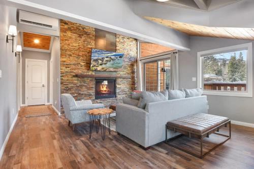 a living room with a couch and a fireplace at Alpine Chalet Nature Lovers Rejoice Chic 4 BDR in Alpine Meadows