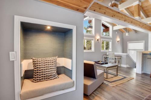 a living room with a couch and a desk with a television at Alpine Chalet Nature Lovers Rejoice Chic 4 BDR in Alpine Meadows