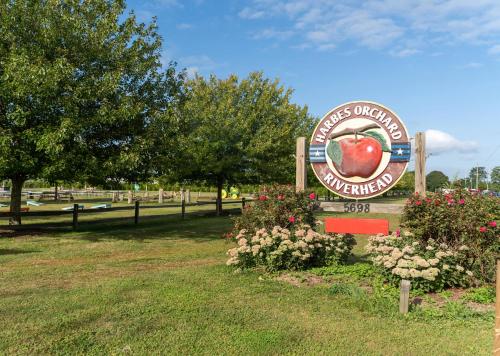 a sign for an apple center in a park at Private Waterfront Home: Dock, Kayaks in Southold