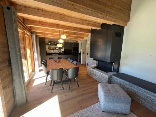 a dining room with a table and a fireplace at Chalet Les 3 Ours by Leavetown Vacations in Les Deux Alpes