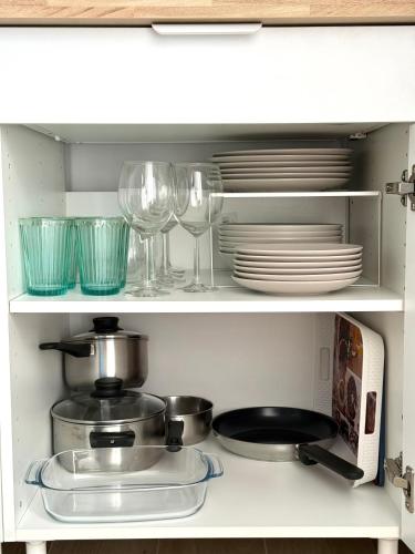 a kitchen cabinet with plates and wine glasses at Superior guest house-Ideal PAREJAS in Conil de la Frontera
