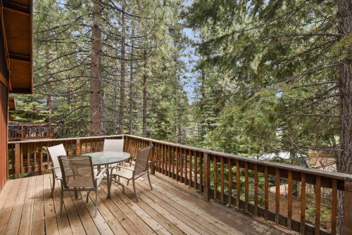 a wooden deck with a table and chairs on it at Kings Beach Bliss Walk to Outdoor Fun in Kings Beach