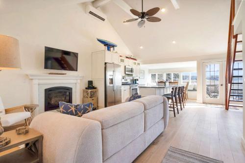 a living room with a couch and a fireplace at After Dune Delight: Steps to Beach in Wading River