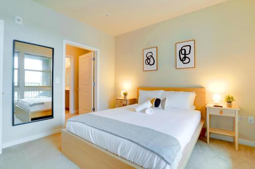 a bedroom with a large bed and a mirror at Exquisite One-Bedroom Apartment in Alexandria in Alexandria