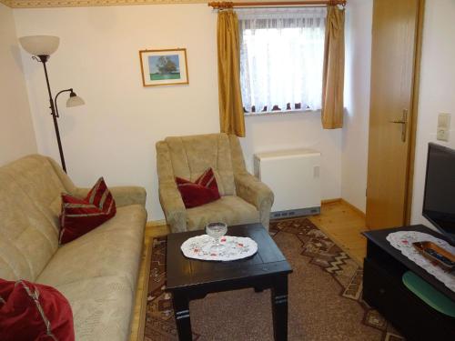 a living room with a couch and two chairs and a table at Ferienhaus Sylvia in Basedow in Basedow