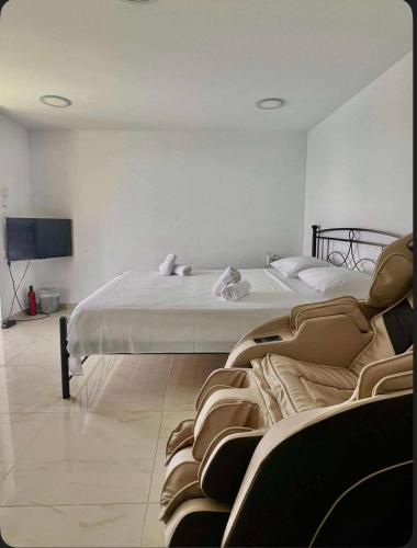 a bedroom with two beds and a flat screen tv at Aronis Spyros Panoramic Seaview Apartments in Longós