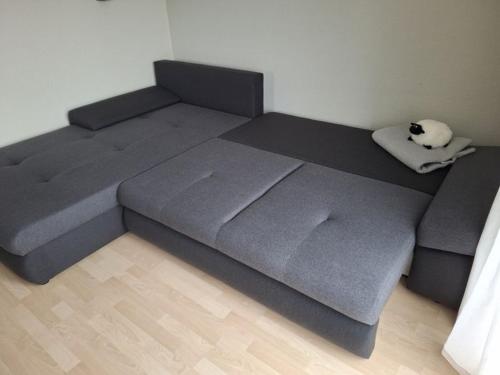 a bed with a cat laying on top of it at Ferienwohnung Janine in Neubrandenburg
