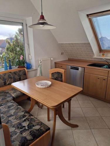 a kitchen with a wooden table and a dining room at Ferienwohnung Janine in Neubrandenburg