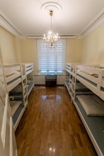 a room with three bunk beds and a chandelier at K Nest in Belgrade
