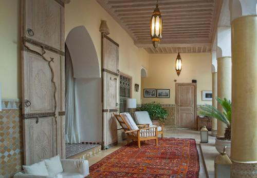 a living room with a couch and a chair at Riad Azoulay in Marrakech