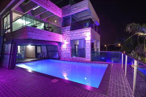 a house with a swimming pool at night at the royal lake views in Tiberias