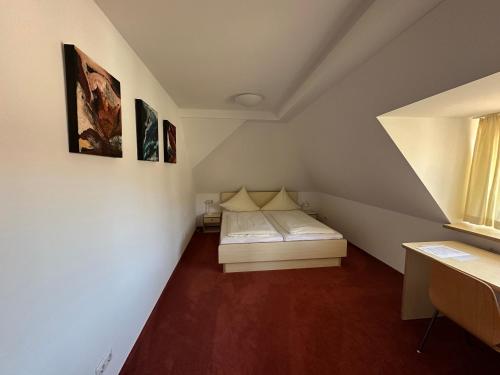 a small room with a bed in a attic at GER-Haus in Waischenfeld