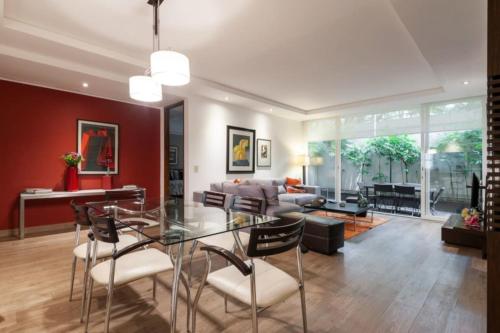 a living room with a glass table and chairs at Mi casa #2 at Polanco's most exclusive area in Mexico City