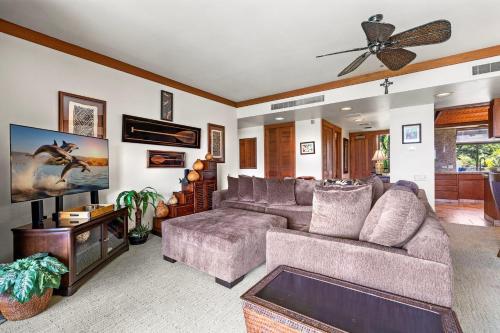a living room with a couch and a ceiling fan at Mauna Lani Terrace D203 in Waikoloa