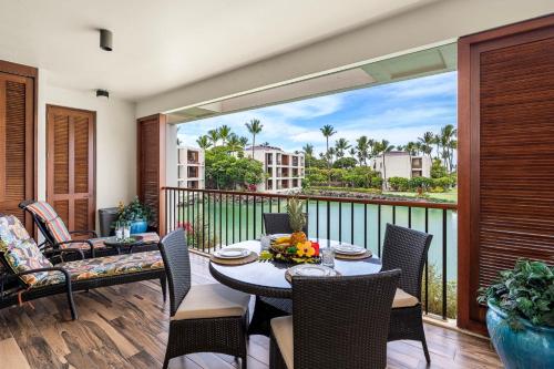a patio with a table and chairs on a balcony at Mauna Lani Terrace D203 in Waikoloa
