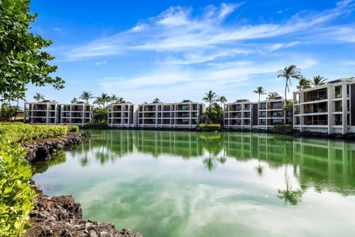 a pool of water in front of apartment buildings at Mauna Lani Terrace D203 in Waikoloa