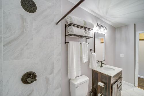 a white bathroom with a toilet and a sink at 7 Mi to Dtwn Tulsa Dog-Friendly Home with Yard in Tulsa