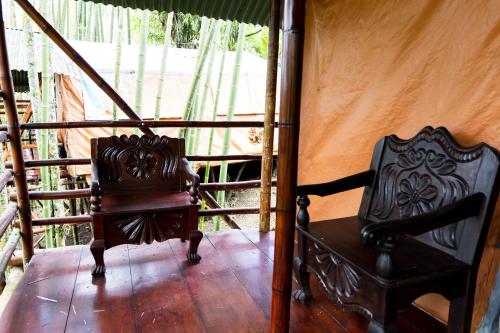 a couple of chairs sitting on a porch at Essence Arenal Spa & Yoga in El Castillo de La Fortuna