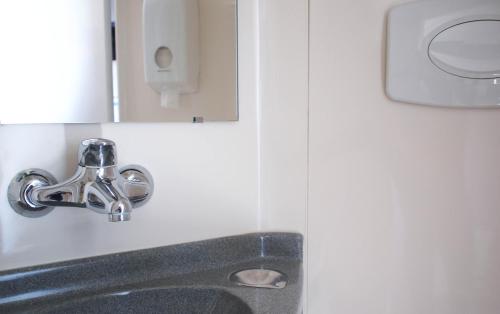 a bathroom sink with a faucet and a mirror at Premiere Classe Niort Est - Chauray in Niort