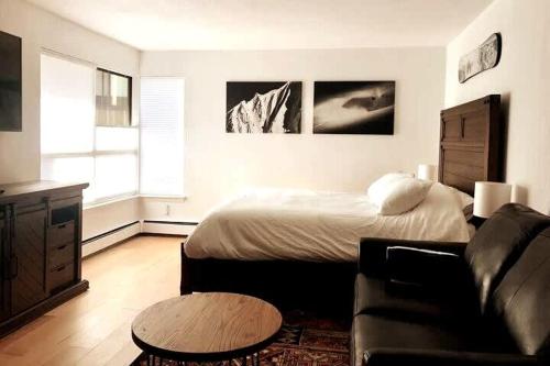 a bedroom with a bed and a couch and a table at Studio Shred Your Cozy Mtn Refuge in Vail