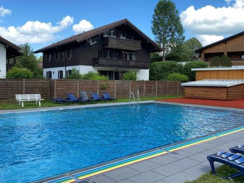 a large swimming pool in front of a house at Ferienhaus Gamssteige im Feriendorf Reichenbach G25b in Nesselwang