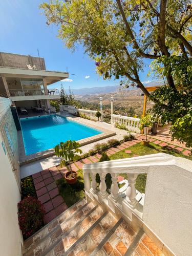a swimming pool in the backyard of a house at Hotel Club Las Flores Ayacucho in Ayacucho