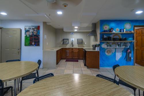 a room with two tables and a kitchen at NY Moore Hostel in Brooklyn