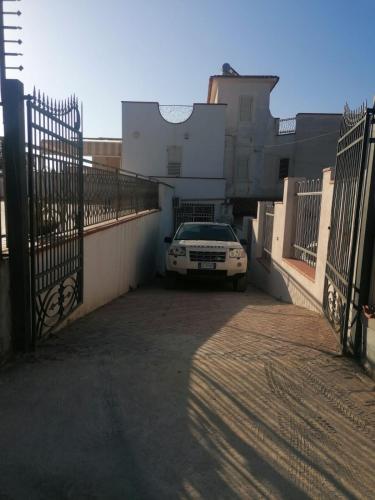 a car parked in a parking lot next to a fence at Casa Tio Pepe in Zingarello