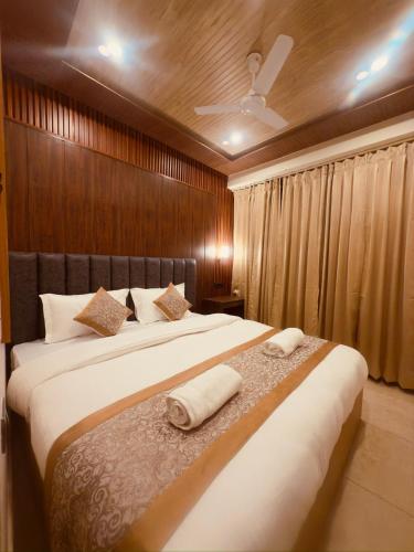 a bedroom with two beds with white towels on them at Milam Hostel in Leh