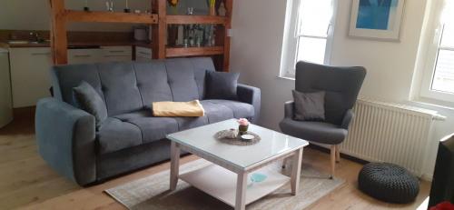 a living room with a couch and two chairs and a table at Ferienwohnung Tegge in Welzin