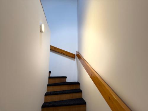 a staircase in a house with white walls at Gaucho Home in Fußach