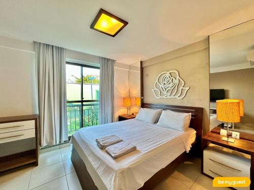 a bedroom with a large bed and a window at Condomínio Mediterranee Residence por Be My Guest in Aquiraz