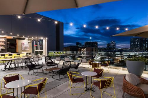 a rooftop patio with tables and chairs at night at Hyatt Place Tempe Phoenix University in Tempe