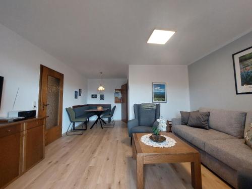 a living room with a couch and a table at Fewo mit malerischem Bergblick im in Bischofsmais