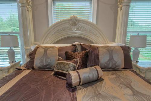 a bedroom with a large bed with pillows on it at The Panola Mansion - Indoor Pool & Pavilion in Stockbridge