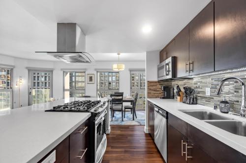 a kitchen with a sink and a stove top oven at Modern Luxury 2 Bed with Panoramic City Views in Downtown LA in Los Angeles