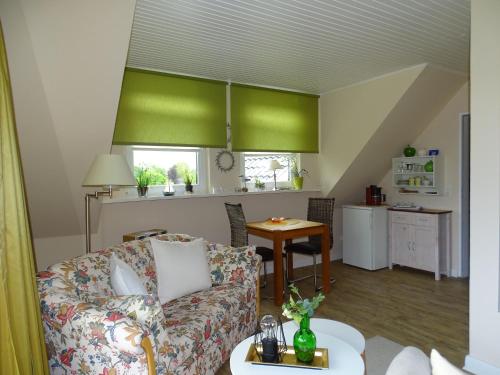 a living room with a couch and a table at Gästehaus Schuppe in Tarp in Tarp