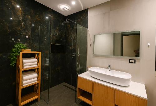 a bathroom with a sink and a shower at Rosemarine Villas in Durrës