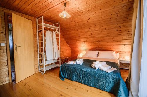a bedroom with a bed in a wooden cabin at Log Cabin Vista View with Seasonal Hot Tub in Bizeljsko