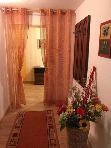a living room with a vase of flowers on a table at Ferienwohnung Frohmut in Burg Stargard