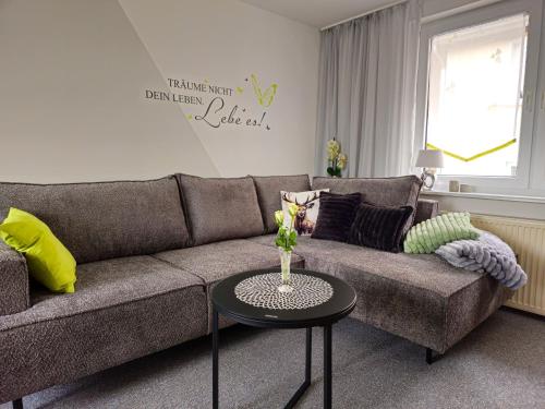 a living room with a couch and a table at Ferienwohnung Martina in Hasselfelde