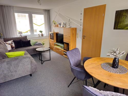 a living room with a couch and a table at Ferienwohnung Martina in Hasselfelde