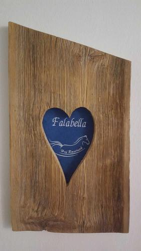 a heart shaped plaque on a wooden wall at Hof Rossruck in Fischbachau