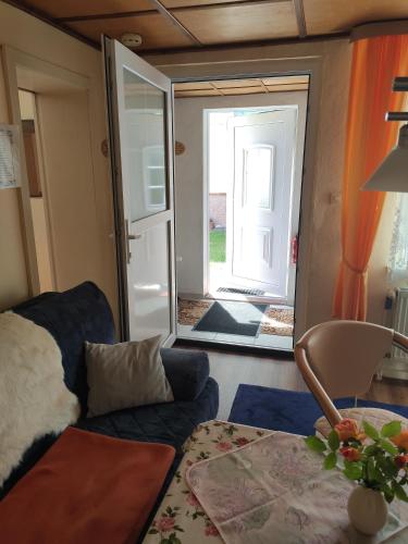 a living room with a couch and a sliding glass door at Ferienhaus Bützow in Güstrow