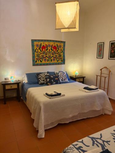 a bedroom with a large bed with two tables at Casa l’orizzonte azzurro in Pula