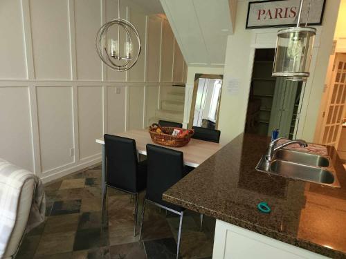 une cuisine avec un comptoir avec des chaises et un évier dans l'établissement Central Townhouse Richards Street, à Vancouver