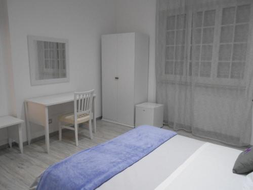 a bedroom with a bed and a desk and a table at Mattandre in Monteroni di Lecce