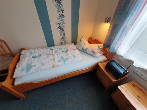 a small bedroom with a bed and a window at Nelius - Ferienhaus 1 in Stiege