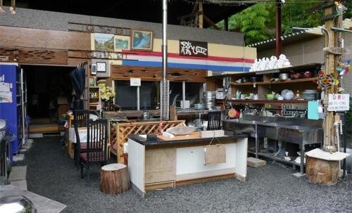 a restaurant with a counter and a table and chairs at Shinfuji Auto Campsite - Vacation STAY 53263v in Kami-ide