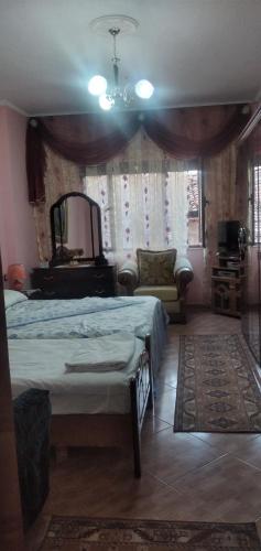 a bedroom with a bed and a mirror at Vila Elio in Pogradec